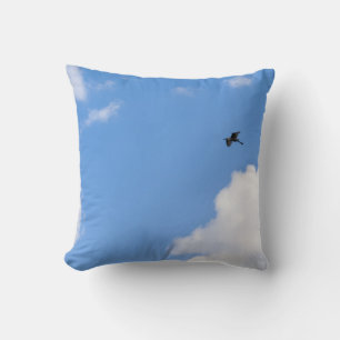 Solitary Bird Soaring Through Bright Blue Sky with Cushion
