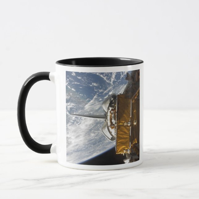 Space Shuttle Atlantis' payload bay backdropped Mug (Left)
