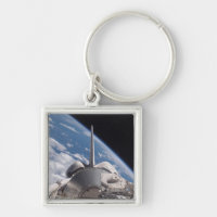Space Shuttle Discovery backdropped by Earth