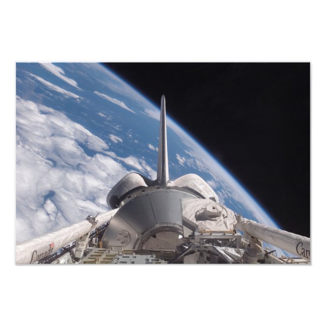 Space Shuttle Discovery backdropped by Earth Photo Print (Front)