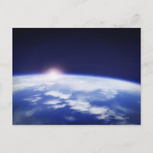 Space with rising sun above planet earth postcard