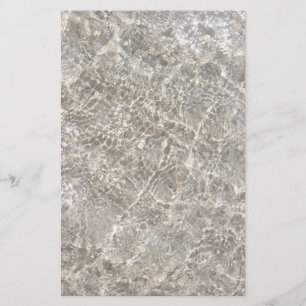 Sparkling water on beach sand summer stationery