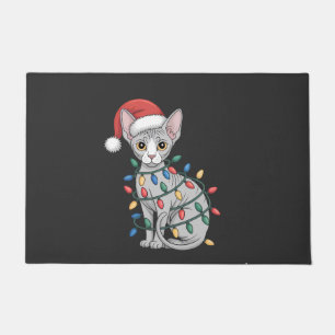 Sphynx Cat Wearing a Santa Hat and Wrapped in Xmas Doormat