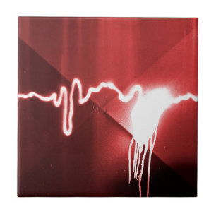 Sprayed graffiti on red metal tile