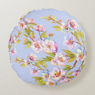 Sprigs of flowering apple or cherry trees on the b round cushion