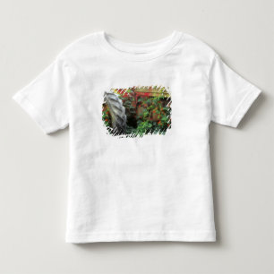 Spring flowers adorn an old tractor. toddler T-Shirt