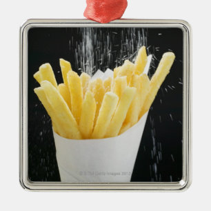 Sprinkling salt on chips in paper cone metal tree decoration