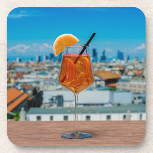 Spritz cocktail on a table with view of Milan Coaster