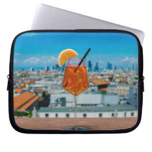 Spritz cocktail on a table with view of Milan Laptop Sleeve
