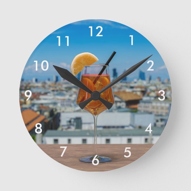 Spritz cocktail on a table with view of Milan Round Clock (Front)