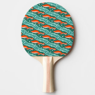 Squirrels jumping in the snow on a dark green tree ping pong paddle