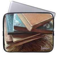stack of books on old chair laptop sleeve