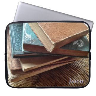 stack of books on old chair laptop sleeve