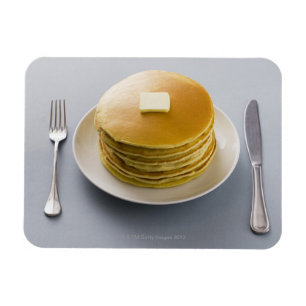 Stack of pancakes with butter on a plate magnet