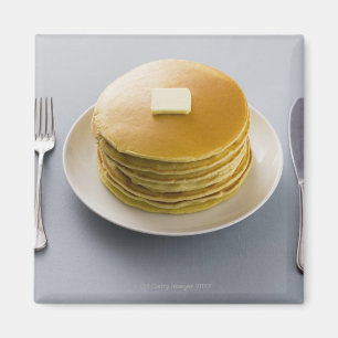 Stack of pancakes with butter on a plate magnet