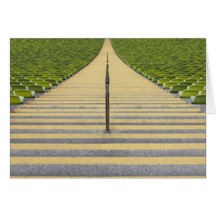Stadium stairway between rows of green seats