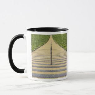 Stadium stairway between rows of green seats mug