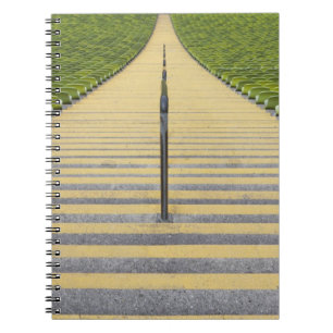 Stadium stairway between rows of green seats notebook