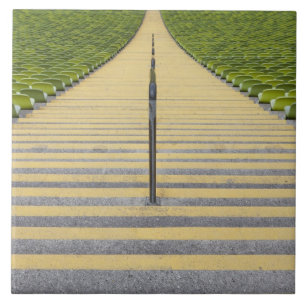 Stadium stairway between rows of green seats tile