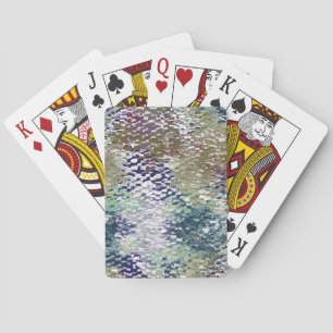 Stains and splatters of paint under hammered glass playing cards