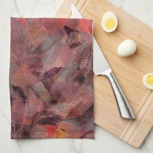 Stains in red hues on black grey grainy background tea towel