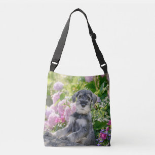 Standard Schnauzer Puppy in a Flowering Garden - Crossbody Bag