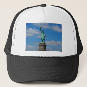Statue of Liberty against a blue sky Trucker Hat