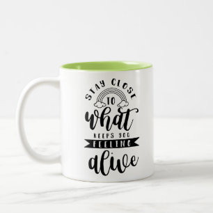 Stay close to what keeps you feeling alive Two-Tone coffee mug
