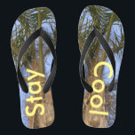 Stay Cool Palm Trees Blue Sky Flip Flops<br><div class="desc">Palm Trees with a Pretty Blue Sky Unisex Flip Flops. With the wording in a sunny yellow, Stay Cool. Perfect for summer fun flip flops for Male or Female for anyone who loves the summer and sand between their toes, or for a beach destination wedding. Shown with a Blue strap....</div>