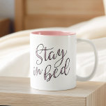 Stay in Bed Rose Quartz Typography Quote Two-Tone Coffee Mug<br><div class="desc">Take your morning coffee in bed with our super cute typography quote mug. Design features "Stay in Bed" in black handwritten style script typography,  filled in with pink Rose Quartz,  a 2016 colour of the year. Looks great on the two-tone mug with pink interior!</div>