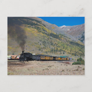 Steam train leaving town postcard