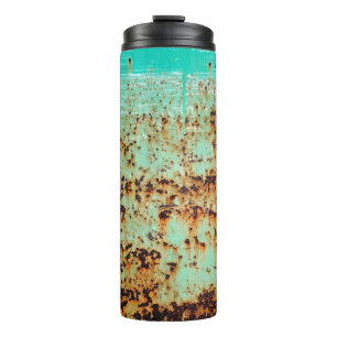 steel surface. An old weathered Green Thermal Tumbler
