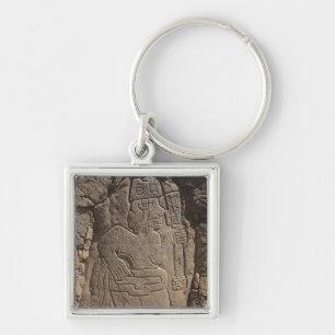 Stela depicting a warrior holding a club key ring