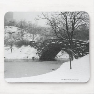 Stone bridge over snow covered river mouse mat