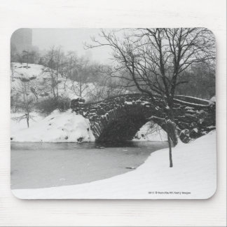 Stone bridge over snow covered river mouse mat