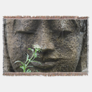 Stone garden statue with flower throw blanket