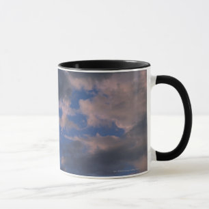 Storm clouds against blue sky mug