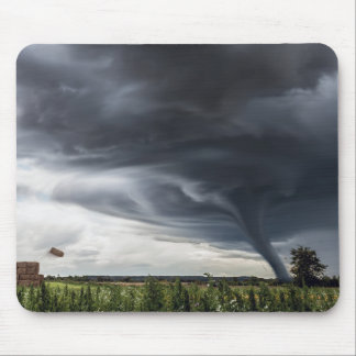 Storm tornado or twister lifing hay in bad weather mouse mat