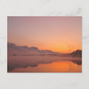 Stormfront coming, orange sunrise at lake postcard