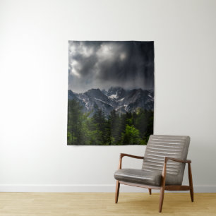 Stormy skies above mountains and spring forest tapestry