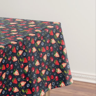 Strawberries and cherries on a dark background tablecloth
