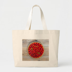 Strawberry cake with mint leaves on a rustic wood large tote bag