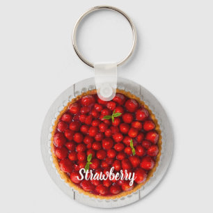 Strawberry cake with mint on white wood key ring