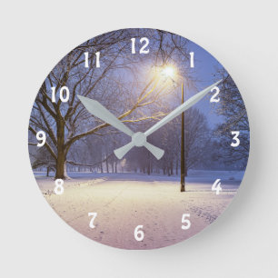 Street lights and covered in snow trees round clock