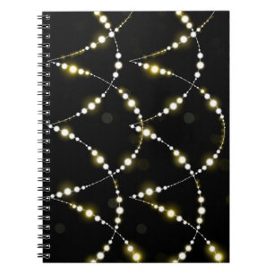 String of Glowing Lights on Black Notebook