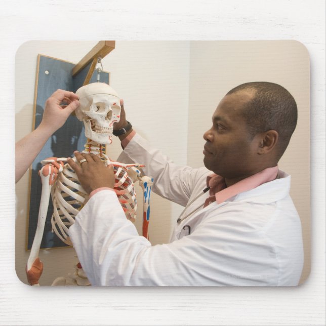 Student doctors studying anatomy on a skeleton mouse mat (Front)