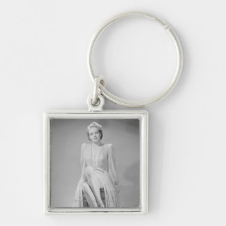 Studio portrait of young woman in nightgown key ring
