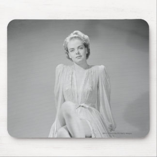Studio portrait of young woman in nightgown mouse mat