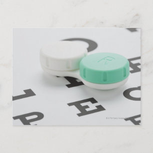 Studio shot of contact lens case on eye chart postcard