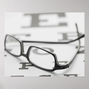Studio shot of eyeglasses on eye chart